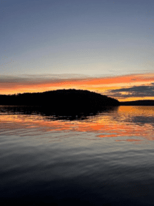 A pink and yellow sunset over Percy Lake.